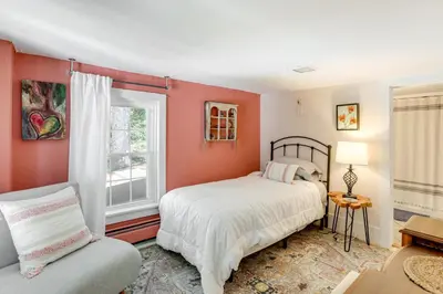 a bedroom with a bed and a window at Lambertville Retreat - Walk to Shopping and Dining! in Lambertville