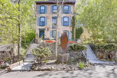 a building with a staircase in front of a house at Lambertville Retreat - Walk to Shopping and Dining! in Lambertville