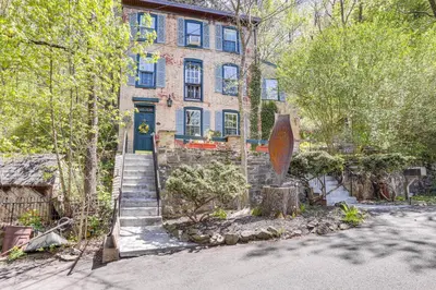 a brick house with a staircase leading to the front door at Lambertville Retreat - Walk to Shopping and Dining! in Lambertville