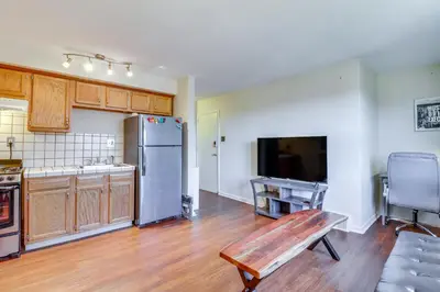 a kitchen with a stainless steel refrigerator and a table at Cozy Easton Condo Near Historic Downtown in Easton