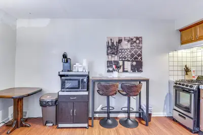a kitchen with a counter and two bar stools at Cozy Easton Condo Near Historic Downtown in Easton
