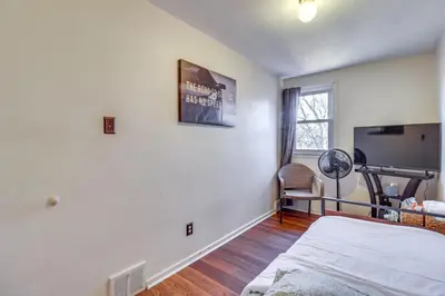 a bedroom with a bed and a tv on a wall at Cozy Easton Condo Near Historic Downtown in Easton