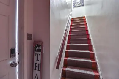 a staircase in a building with red and gray stairs at Cozy Easton Condo Near Historic Downtown in Easton