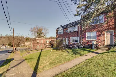 a brick house on the side of a street at Cozy Easton Condo Near Historic Downtown in Easton