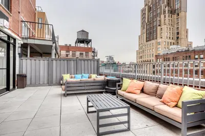 a patio with couches and a table on a building at Chelsea 1br w doorman lounge nr food hall NYC-1196 in New York