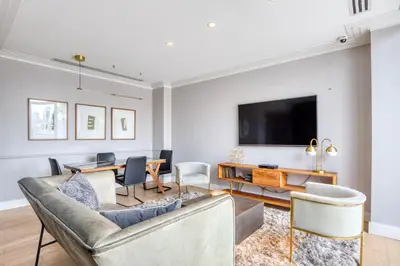 a living room with a couch and a tv at Chelsea 1br w doorman lounge nr food hall NYC-1196 in New York
