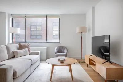 a living room with a couch and a tv at Chelsea 1br w doorman lounge nr food hall NYC-1196 in New York