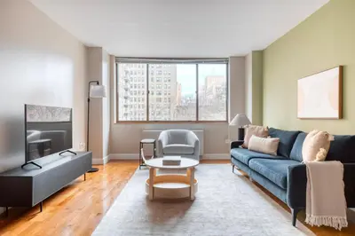 a living room with a couch and a table at UWS 2br w gym doorman elevator nr Central Park NYC-1047 in New York