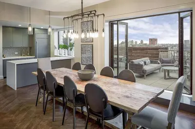 a kitchen and dining room with a wooden table and chairs at UWS 2br w gym doorman elevator nr Central Park NYC-1047 in New York