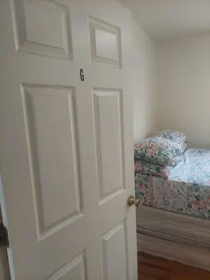 an open door with a bed in a room at Crystal Room 1 Guest House near 12mins to EWR airport / Prudential / NJIT / Penn station in Newark