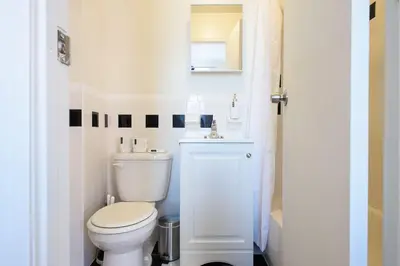 a white bathroom with a toilet and a sink at Renovated 1br in East Village in New York