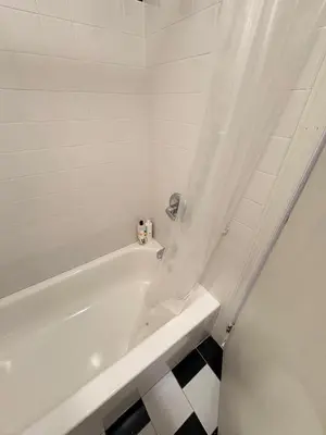 a white bath tub with a shower curtain in a bathroom at Renovated 1br in East Village in New York