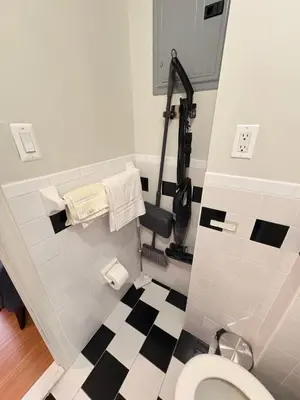 a bathroom with a toilet and a black and white checkered floor at Renovated 1br in East Village in New York