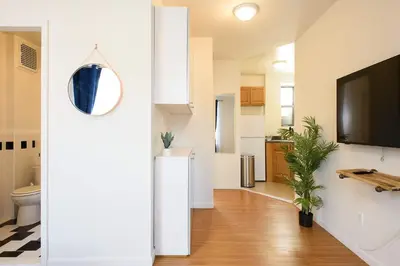 a living room with a toilet and a tv at Renovated 1br in East Village in New York