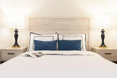a bedroom with a white bed with two lamps at Renovated 1br in East Village in New York