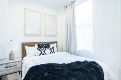 a white bedroom with a bed and a window at 180-2 Brand new 2BR 1Bath East Village in New York