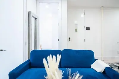 a blue couch sitting in a living room at 180-2 Brand new 2BR 1Bath East Village in New York