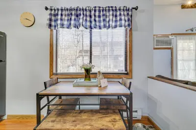 a table in a room with a window at Fire Pit, Pool and Beach Access Tobyhanna Home! in Tobyhanna