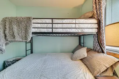 a bedroom with two bunk beds in a room at Fire Pit, Pool and Beach Access Tobyhanna Home! in Tobyhanna