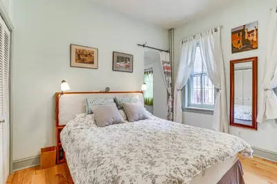 a bedroom with a bed and two windows at MCM-Inspired Philadelphia Apartment Private Deck in Philadelphia
