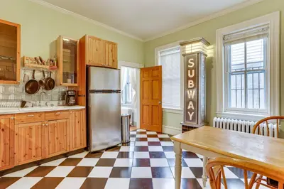 a kitchen with a stainless steel refrigerator and a checkered floor at MCM-Inspired Philadelphia Apartment Private Deck in Philadelphia