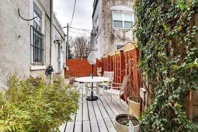 a wooden deck with a table and chairs on it at MCM-Inspired Philadelphia Apartment Private Deck in Philadelphia