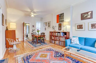 a living room with a blue couch and a table at MCM-Inspired Philadelphia Apartment Private Deck in Philadelphia