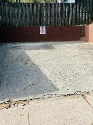 a no parking sign in front of a fence at Single Room with Bathroom in Irvington