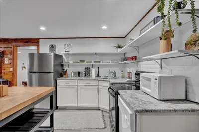 a large kitchen with white cabinets and appliances at Cabin in Long Pond Gameroom Pool Table in Long Pond