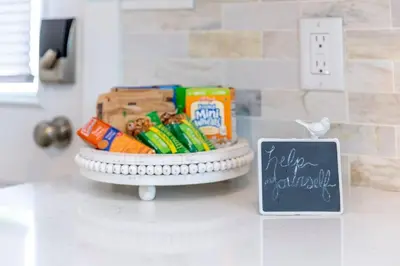 a basket of snacks on a counter next to a chalkboard at AmishGuestCottage~cozystudio~hottub~patio in Gordonville