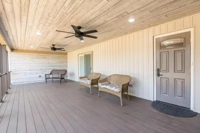 a porch with two chairs and a ceiling fan at The Queen Place - Updated-Private Backyard in Gordonville