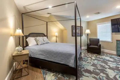 a bedroom with a canopy bed and a chair at The Queen Place - Updated-Private Backyard in Gordonville