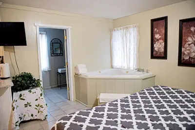 a bedroom with a bed and a bath tub at Berry Patch BnB in Lebanon