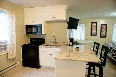 a kitchen with white cabinets and a counter top at Berry Patch BnB in Lebanon