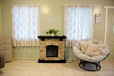 a living room with a chair and a fireplace at Berry Patch BnB in Lebanon