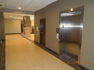 an empty hallway with a metal elevator in a building at Super 8 by Wyndham Hershey Chocolate Avenue in Hershey