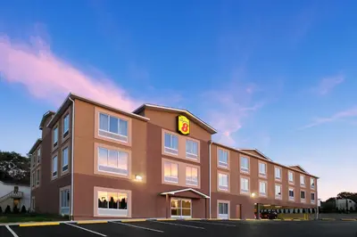 a hotel with a sign on the side of a building at Super 8 by Wyndham Hershey Chocolate Avenue in Hershey