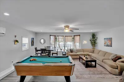 a living room with a pool table in it at Log Cabin and Guest House Sleeps 18 2 Game Rooms in Long Pond