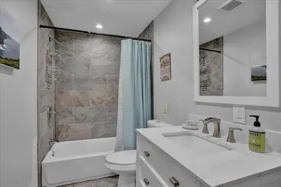 a white bathroom with a sink and a toilet at Log Cabin and Guest House Sleeps 18 2 Game Rooms in Long Pond