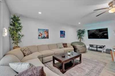 a living room with a couch and a coffee table at Log Cabin and Guest House Sleeps 18 2 Game Rooms in Long Pond