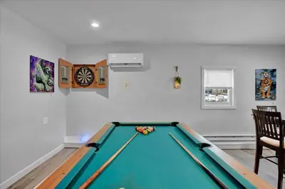 a room with a pool table and a clock at Log Cabin and Guest House Sleeps 18 2 Game Rooms in Long Pond