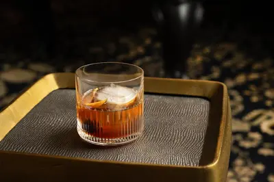a drink in a glass sitting on a tray at Pendry Natirar in Peapack