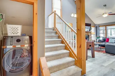 a staircase with a washing machine in a house at Cozy Cove Near Waterparks, Zip Line, Ski and More in Tannersville