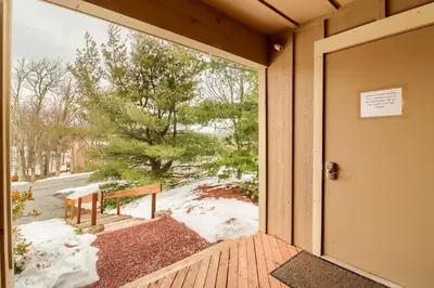 an open door to a porch with snow on the ground at Cozy Cove Near Waterparks, Zip Line, Ski and More in Tannersville