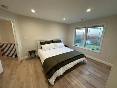 a bedroom with a large bed and a large window at New Farmhouse, King Beds, Game Room, Hot Tub & View! in Montgomery