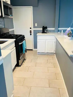 a kitchen with a stove and a tile floor at Two Bedrooms Home in Irvington