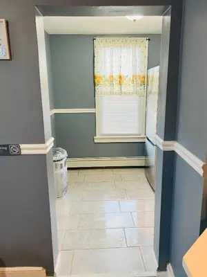 a hallway with a window and a tile floor at Two Bedrooms Home in Irvington