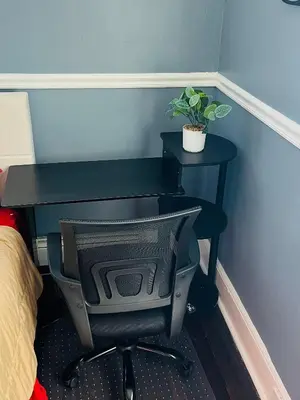 a black desk with a chair and a plant on it at Two Bedrooms Home in Irvington