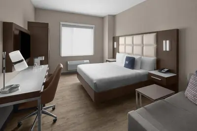 a hotel room with a bed and a desk at Cambria Hotel New York - Chelsea in New York