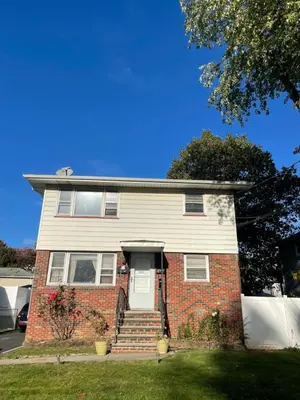 a red brick house with a white door at Cozy Home Near Downtown Rahway in Rahway